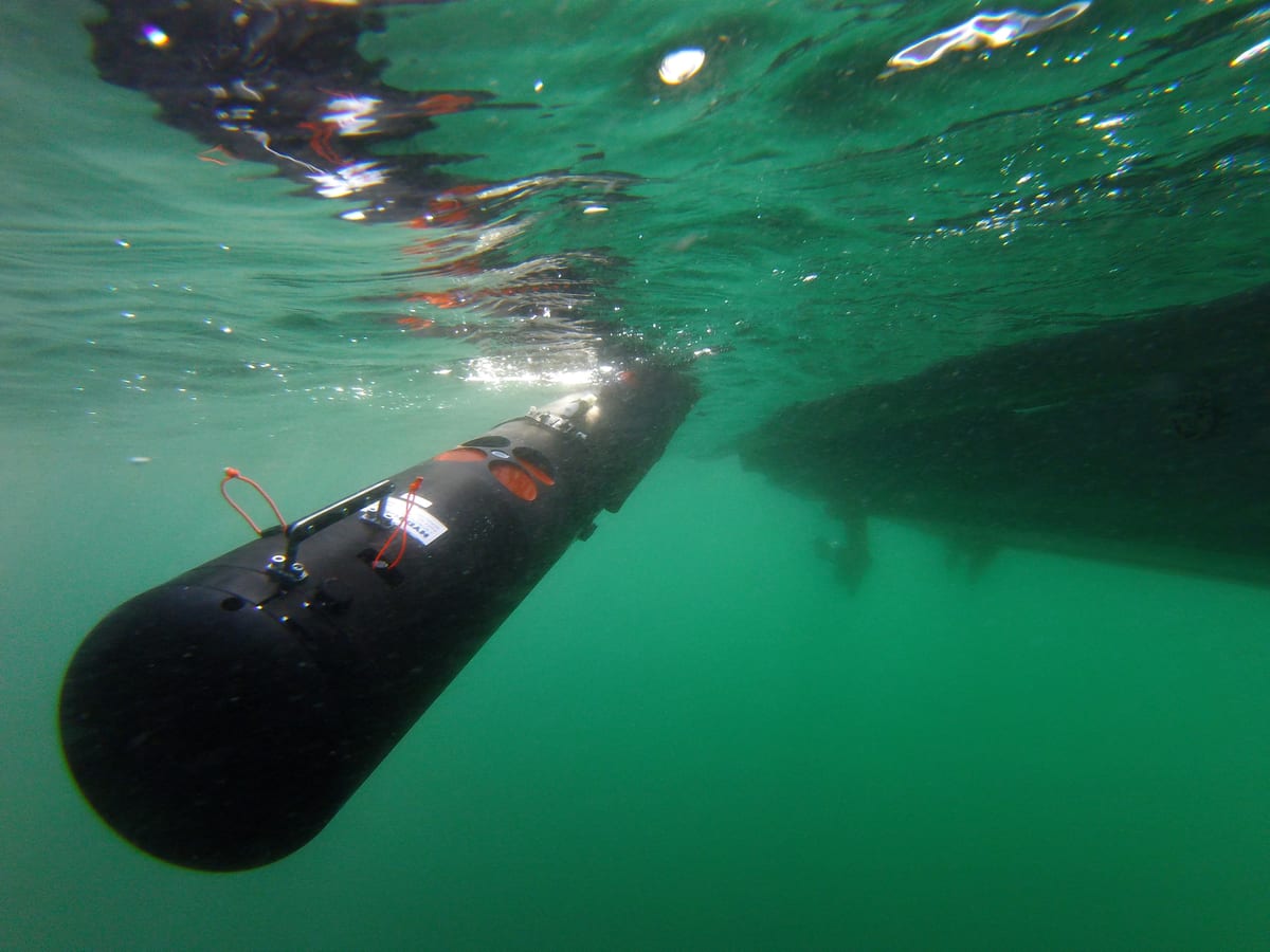REMUS 100 autonomous underwater vehicle entering the water during a NATO maritime systems exercise